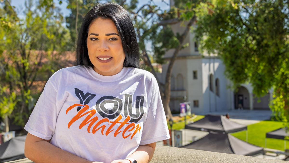 Esmeralda Martinez in front of the quad with trees behind her