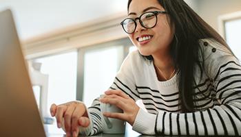 student typing at a computer