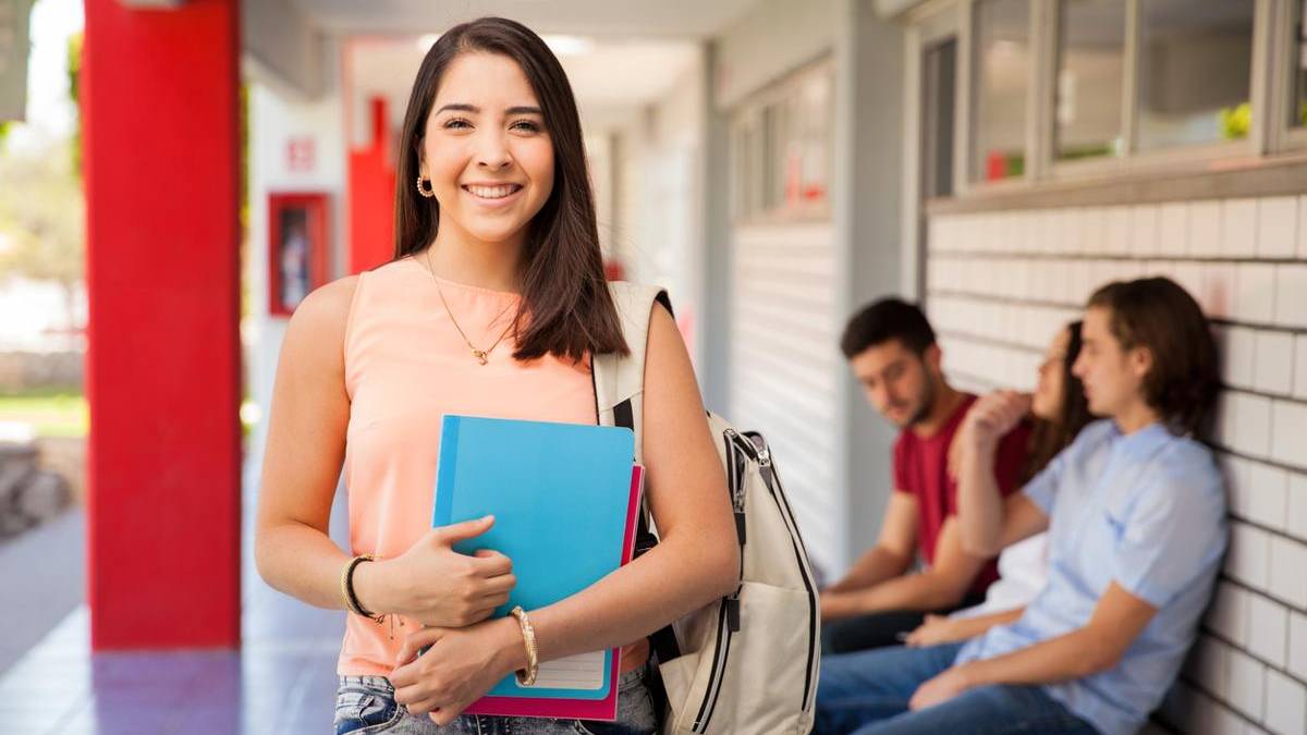 Student holding books and bag