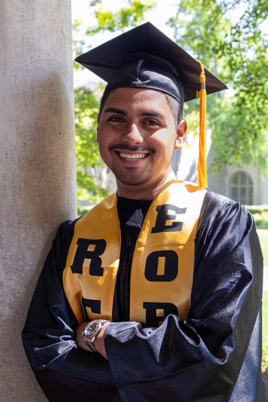 Cristian Castellanos in graduation regalia